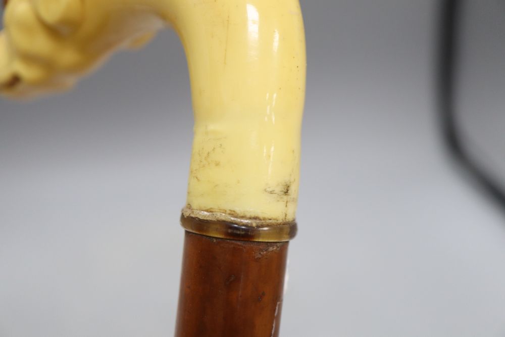 A carved ivory dogs head walking stick, c.1860, length 33cm